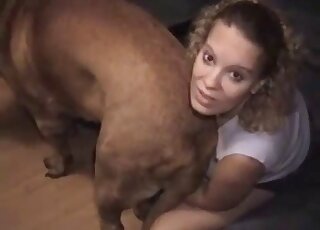 Horny blonde MILF tries to seduce giant Mastiff into fucking