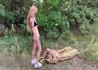 Masked blonde treats her pet dog with a blowjob outdoors