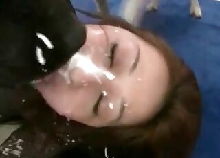 Doggie cums all over the pretty face of an Asian zoophile babe