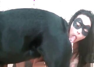 Brunette in a mask takes a dog’s dick in mouth in a zoophilia sex vid