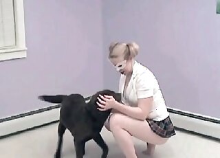 Chick trains her dog indoors teaching it how to lick her pussy
